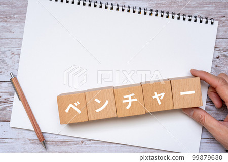 Venture written block, notebook, pen and hand 99879680