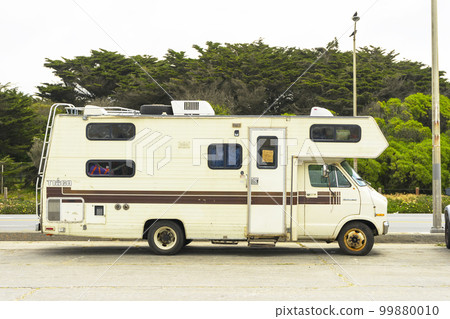 RV camper in a scenic parking spot. Travel trailer camper van. 99880010