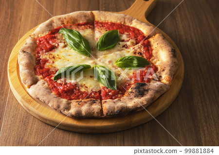 Delicious wood-fired pizza margherita 99881884