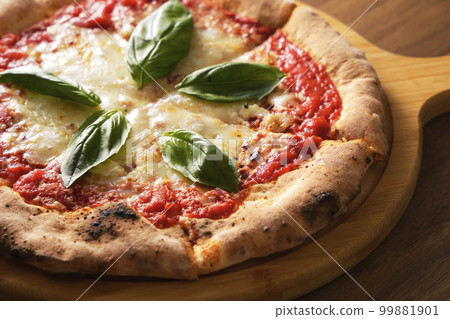 Delicious wood-fired pizza margherita Delicious wood-fired pizza margherita 99881901