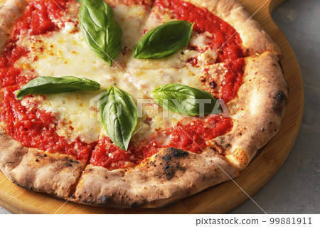 Delicious wood-fired pizza margherita 99881911