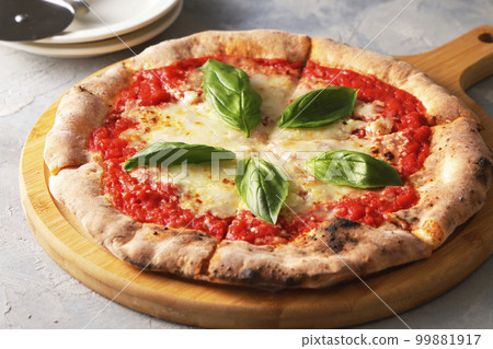 Delicious wood-fired pizza margherita 99881917
