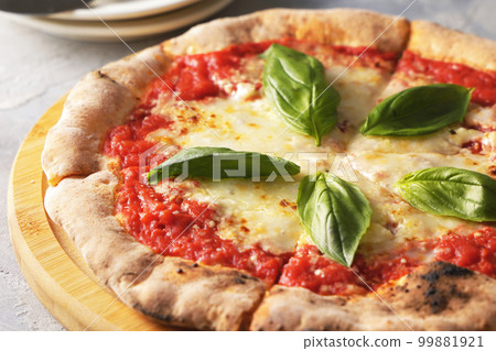 Delicious wood-fired pizza margherita Delicious wood-fired pizza margherita 99881921