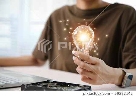 Hand holding light bulb. idea concept with innovation and inspiration Hand holding light bulb. idea concept with innovation and inspiration 99882142