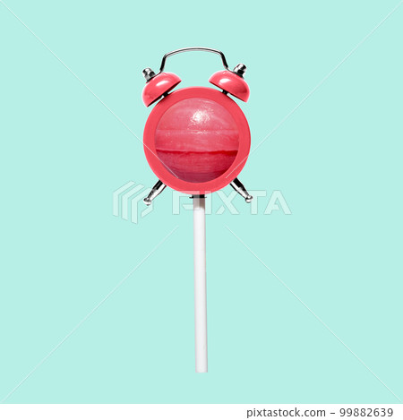 Fun funny candy on a stick and retro alarm clock. Fun funny candy on a stick and retro alarm clock. 99882639