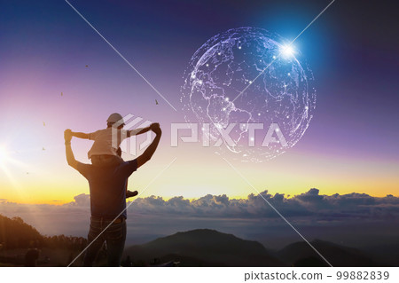 Happy Dad carrying son on shoulders looking future project with world cyber technology Silhouette of father and son. 99882839