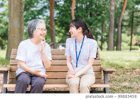 Elderly people talking in the park and a smiling nursing staff woman (talking/fun) Elderly people talking in the park and a smiling nursing staff woman (talking/fun) 99883458