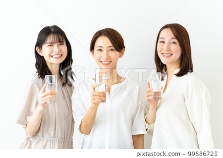 Middle aged woman drinking mineral water Middle aged woman drinking mineral water 99886721