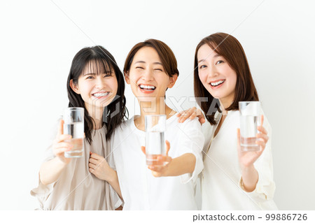Middle aged woman drinking mineral water 99886726