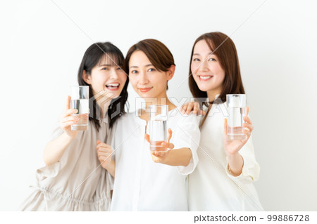 Middle aged woman drinking mineral water Middle aged woman drinking mineral water 99886728