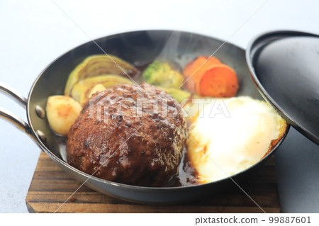 Hamburger and vegetables on a skillet Hamburger and vegetables on a skillet 99887601