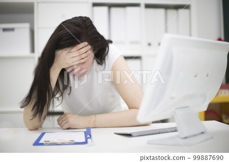 Tired woman at the computer. 99887690