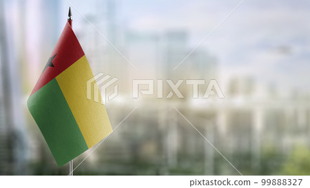Small flags of the Guinea Bissau on an abstract blurry background 99888327