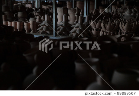 Thai Theravada Buddhism altar fittings quietly waiting for their debut in the dry and unglazed storage room of the Chiang Mai Pottery Studio in Thailand 99889507