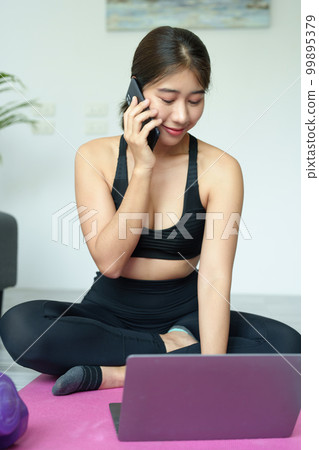 stress relief, muscle relaxation, breathing exercises, exercise, meditation, portrait of Young Asian woman relaxing her body from office work by practicing yoga by watching online tutorials 99895379
