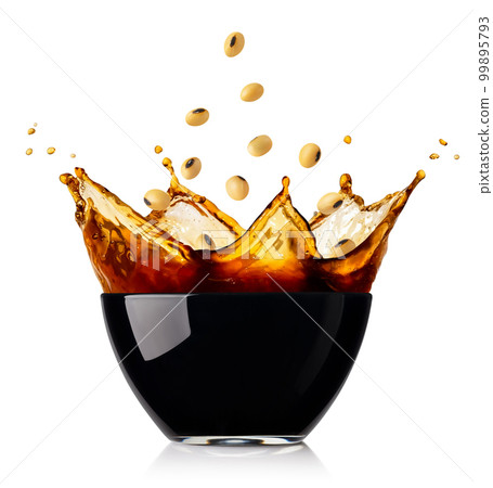 splashing soy sauce in glass bowl with falling soybeans isolated on white splashing soy sauce in glass bowl with falling soybeans isolated on white 99895793