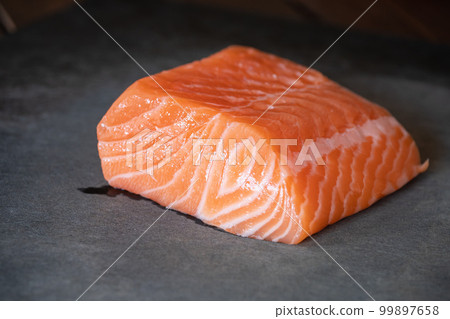 A chunk of raw salmon. Salmon for sashimi. 99897658
