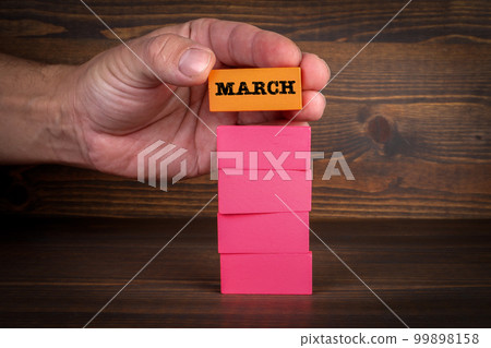 MARCH. Colorful blocks on a dark wood background MARCH. Colorful blocks on a dark wood background 99898158
