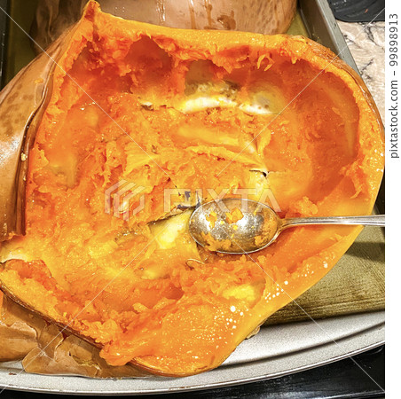 Freshly cooked cheese pumpkin scooped out for pumpkin bread and pie Freshly cooked cheese pumpkin scooped out for pumpkin bread and pie 99898913
