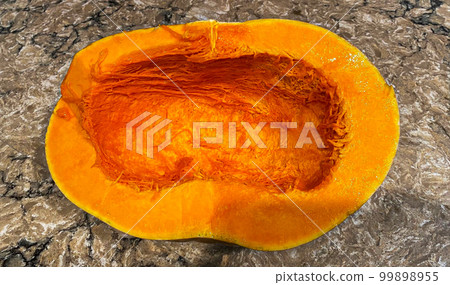 Looking down at a scooped out cheese pumpkin ready to be baked 99898955