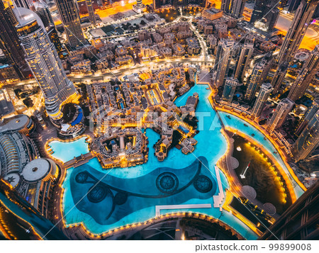 Aerial view of Downtown Dubai with roads, Dubai Mall and the fountain at sunrise, from Burj Khalifa 99899008