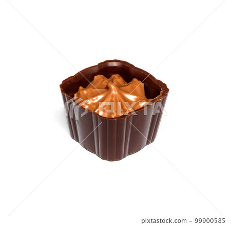 Chocolate candy with cream on a white isolated background. Idea for dessert in a restaurant Chocolate candy with cream on a white isolated background. Idea for dessert in a restaurant 99900585