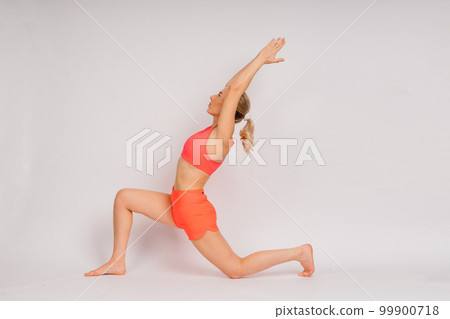 Beautiful female with dumbbells posing on studio background Beautiful female with dumbbells posing on studio background 99900718