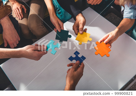 Teamwork of partners connect puzzle pieces as integration and startup 99900821