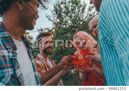 Friends have a picnic and toast with wine Friends have a picnic and toast with wine 99901155