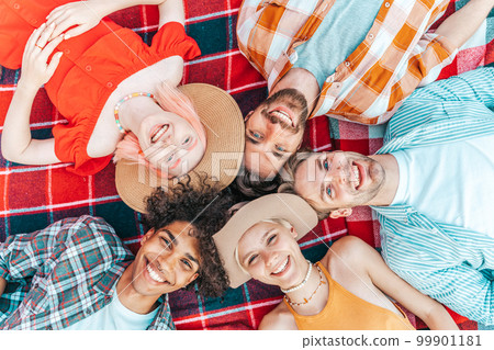 Group of friend relax together lying down in summer 99901181