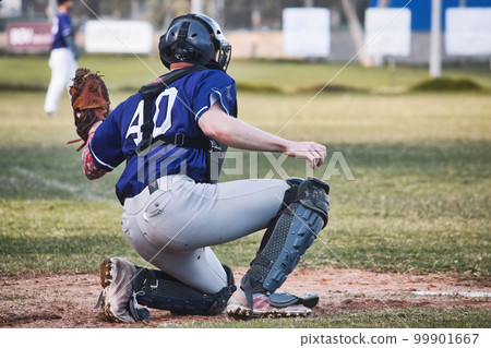 A baseball catcher holding up a leather glove on one knee on the pitch A baseball catcher holding up a leather glove on one knee on the pitch 99901667
