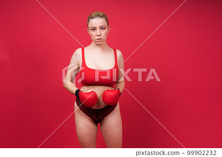A beautiful, attractive, seductive girl with blonde hair in the studio. 99902232