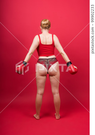 A beautiful, attractive, seductive girl with blonde hair in the studio. 99902233