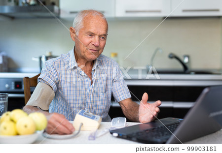 Man having video call with doctor, using laptop at home Man having video call with doctor, using laptop at home 99903181
