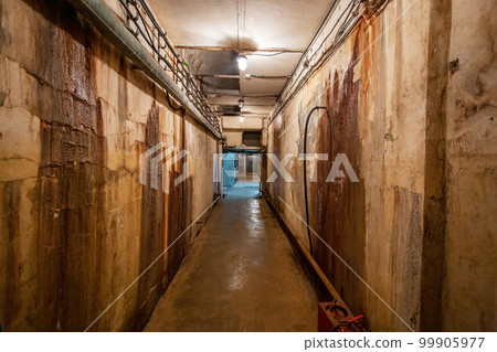 Abstract dark corridor of military bunker interior, grungy old underground tunnel. Nuclear shelter Abstract dark corridor of military bunker interior, grungy old underground tunnel. Nuclear shelter 99905977