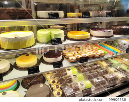 MELAKA, MALAYSIA - MARCH 4, 2022: Various types of cakes with various flavors are on display in the chiller display. Price tags are provided to make it easier for customers to buy. 99906586