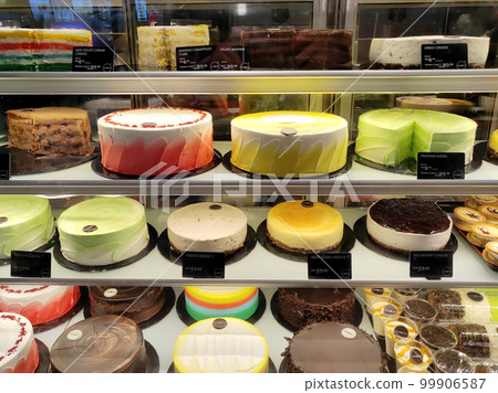 MELAKA, MALAYSIA - MARCH 4, 2022: Various types of cakes with various flavors are on display in the chiller display. Price tags are provided to make it easier for customers to buy. 99906587