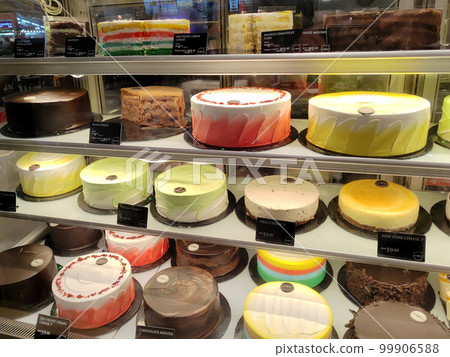 MELAKA, MALAYSIA - MARCH 4, 2022: Various types of cakes with various flavors are on display in the chiller display. Price tags are provided to make it easier for customers to buy. 99906588
