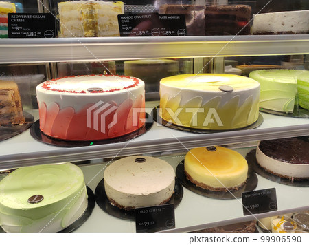 MELAKA, MALAYSIA - MARCH 4, 2022: Various types of cakes with various flavors are on display in the chiller display. Price tags are provided to make it easier for customers to buy. 99906590