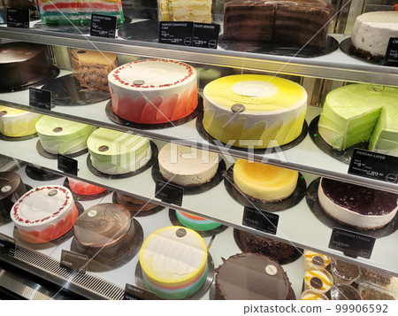 MELAKA, MALAYSIA - MARCH 4, 2022: Various types of cakes with various flavors are on display in the chiller display. Price tags are provided to make it easier for customers to buy. 99906592