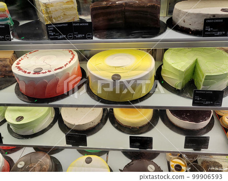 MELAKA, MALAYSIA - MARCH 4, 2022: Various types of cakes with various flavors are on display in the chiller display. Price tags are provided to make it easier for customers to buy. 99906593