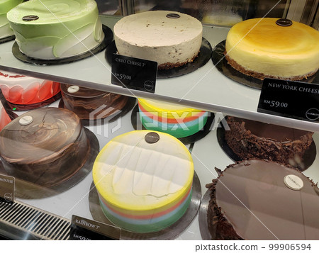 MELAKA, MALAYSIA - MARCH 4, 2022: Various types of cakes with various flavors are on display in the chiller display. Price tags are provided to make it easier for customers to buy. 99906594