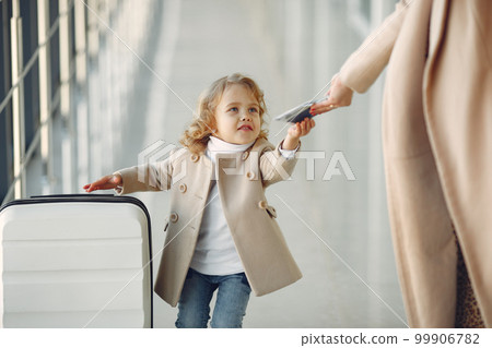 Family at the airport. Mother with daughter. Woman with suitcase. 99906782