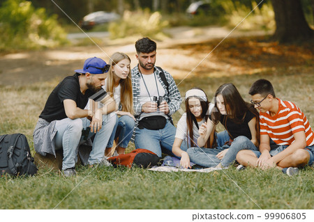 Adventure, travel, tourism, hike and people concept. Group of smiling friends in a forest. Adventure, travel, tourism, hike and people concept. Group of smiling friends in a forest. 99906805
