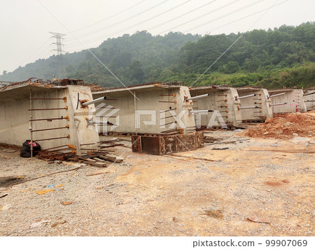 MELAKA, MALAYSIA -MAY 4, 2022: Pre-stress cable in the casing embedded in the concrete. It is part of the prestressed concrete. It is used to improve concrete slab quality with a larger span. MELAKA, MALAYSIA -MAY 4, 2022: Pre-stress cable in the casing embedded in the concrete. It is part of the prestressed concrete. It is used to improve concrete slab quality with a larger span. 99907069