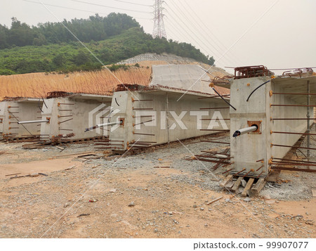 MELAKA, MALAYSIA -MAY 4, 2022: Pre-stress cable in the casing embedded in the concrete. It is part of the prestressed concrete. It is used to improve concrete slab quality with a larger span. MELAKA, MALAYSIA -MAY 4, 2022: Pre-stress cable in the casing embedded in the concrete. It is part of the prestressed concrete. It is used to improve concrete slab quality with a larger span. 99907077