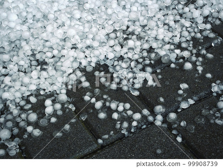 hailstones after a storm on a concrete pavement hailstones after a storm on a concrete pavement 99908739