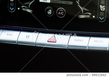 Red triangle hazard light button on car dashboard. Car media buttons dashboard. Red triangle hazard light button on car dashboard. Car media buttons dashboard. 99912682