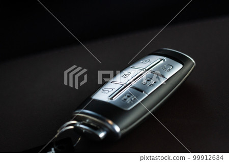Close up of a modern wireless car key. Modern car interior. Close up of a modern wireless car key. Modern car interior. 99912684