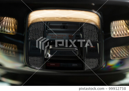Close up image of the SOS button and car ceiling lamp in a car. Close up image of the SOS button and car ceiling lamp in a car. 99912738